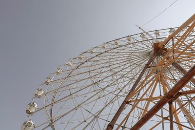 Low angle view of ferris wheel against clear sky