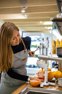 Side view of young woman preparing food in laboratory