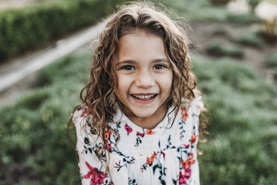 Close up portrait of young school-aged happy girl smiling at