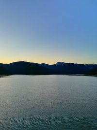 Scenic view of lake against clear blue sky