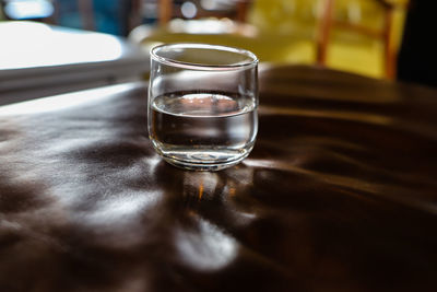 Close-up of water glass on table