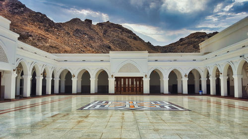 View of mosque against cloudy sky