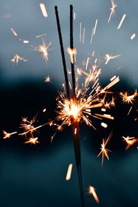 Low angle view of firework display at night