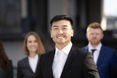 Portrait of smiling young man standing outdoors