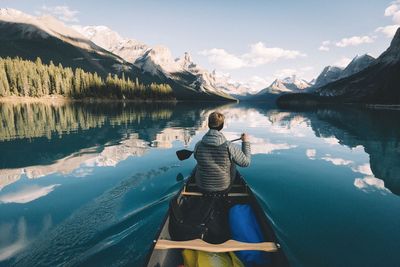 Rear view of one person paddling on maligne lake