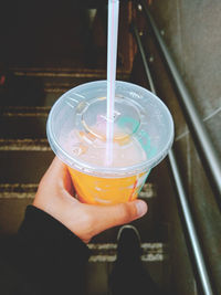 Close-up of hand holding glass of drink