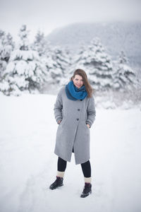 Portrait of man standing on snow