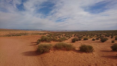 Scenic view of desert land against sky