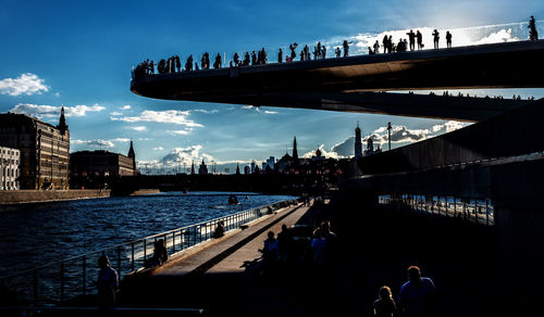 Panoramic view of city by river against sky