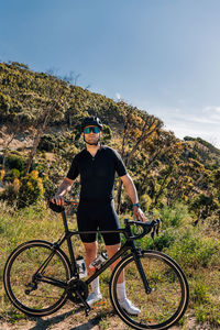 Low angle view of man riding bicycle on mountain