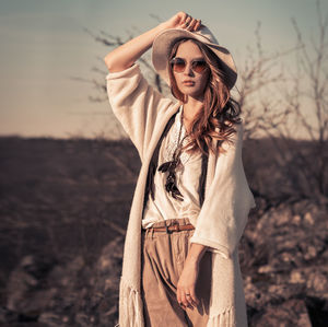 Portrait of fashionable young woman standing outdoors