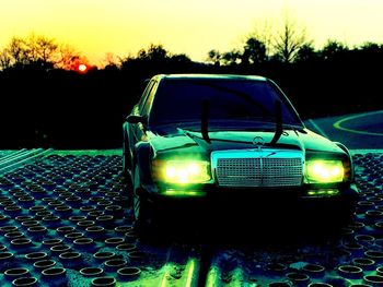 Close-up of illuminated car against sky