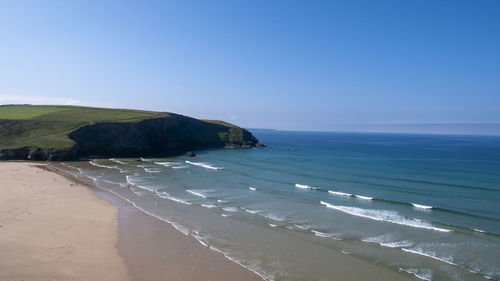 Scenic view of sea against clear blue sky