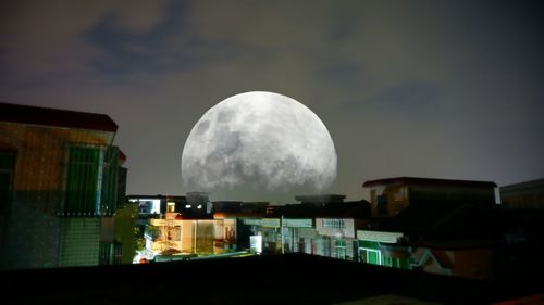 Illuminated built structure against sky at night