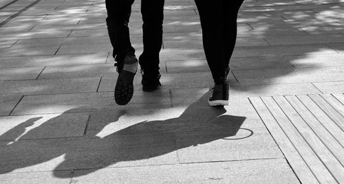 Low section of people walking on footpath