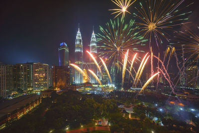 Firework display in city at night