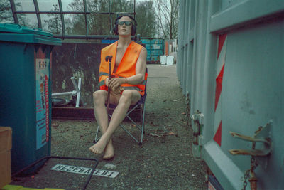Portrait of young woman sitting on chair