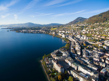 High angle view of townscape by sea against sky