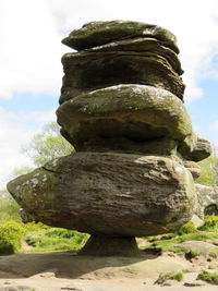 Close-up of rock statue against sky