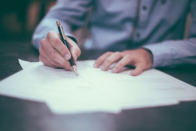 Close-up of human hand holding paper