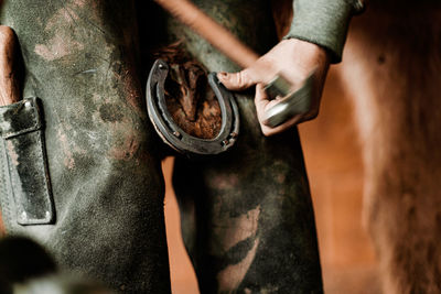 Cropped hand of man working at workshop