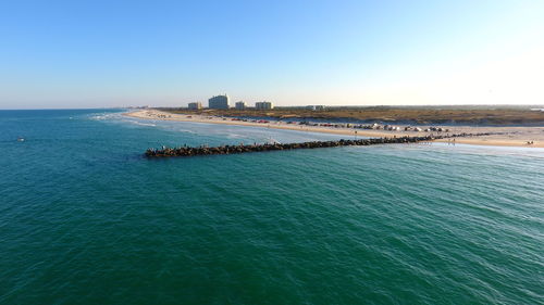 Scenic view of sea against clear blue sky