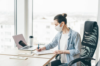 Female doctor working in office