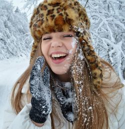 Portrait of smiling young woman in snow