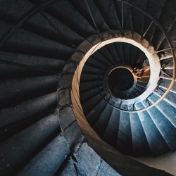 Woman lying down at spiral staircase