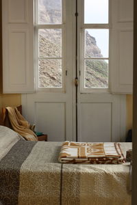 Low section of woman standing by window