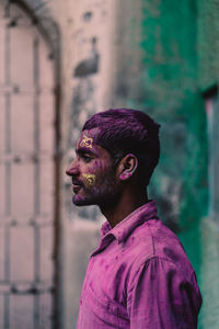Portrait of young man looking away outdoors