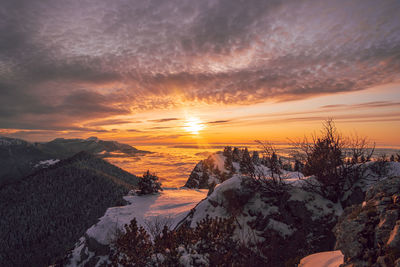 Scenic view of snowcapped mountains against sky during sunset