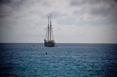 Sailboat sailing on sea against sky