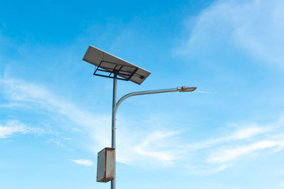 Low angle view of street light against blue sky