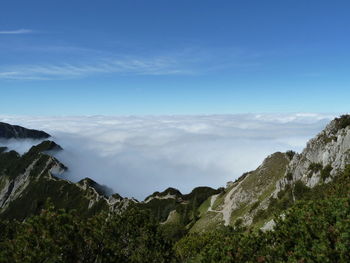 Scenic view of mountains against blue sky