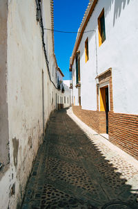 Footpath amidst buildings in town