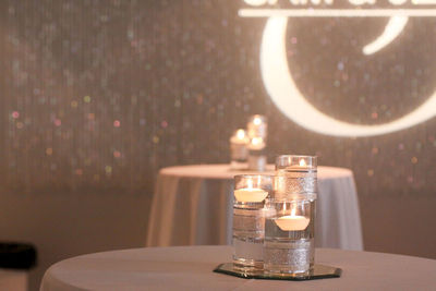 Illuminated candles decorated on dining table at restaurant