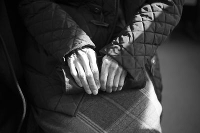 Midsection of woman sitting on seat