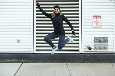 A happy athletic woman jumping.