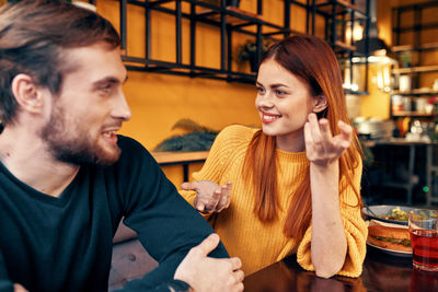 Smiling young couple sitting outdoors