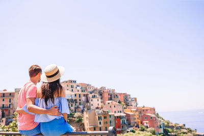 Panoramic view of people standing by cityscape against sky