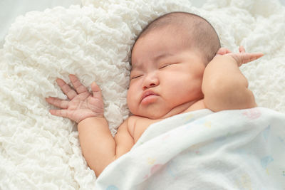 Baby girl sleeping on bed