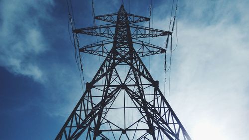 Low angle view of electricity pylon against sky