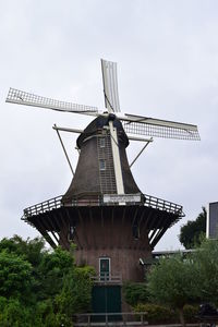 Low angle view of traditional windmill against sky