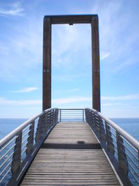 Pier over sea against sky