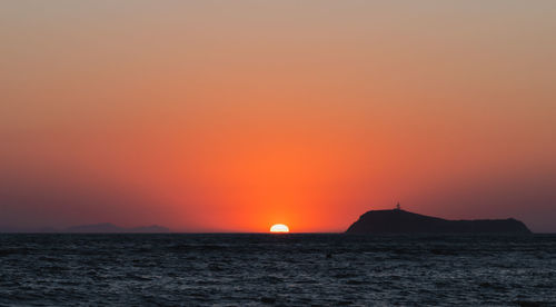 Scenic view of sea against romantic sky at sunset