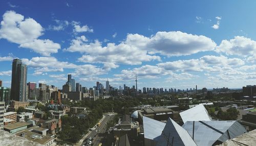 Cityscape against cloudy sky