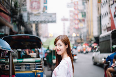 Portrait of woman on road in city