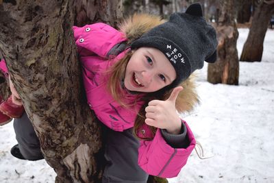 Close-up of young woman with pink hair in snow