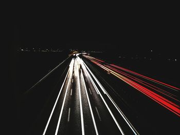 High angle view of light trails on highway at night
